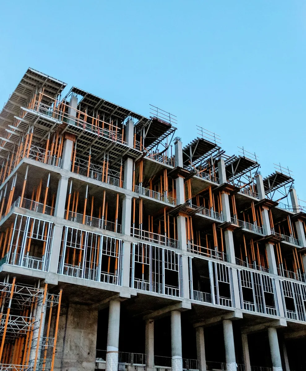 Multi-story commercial concrete structural frame with exterior framing in progress