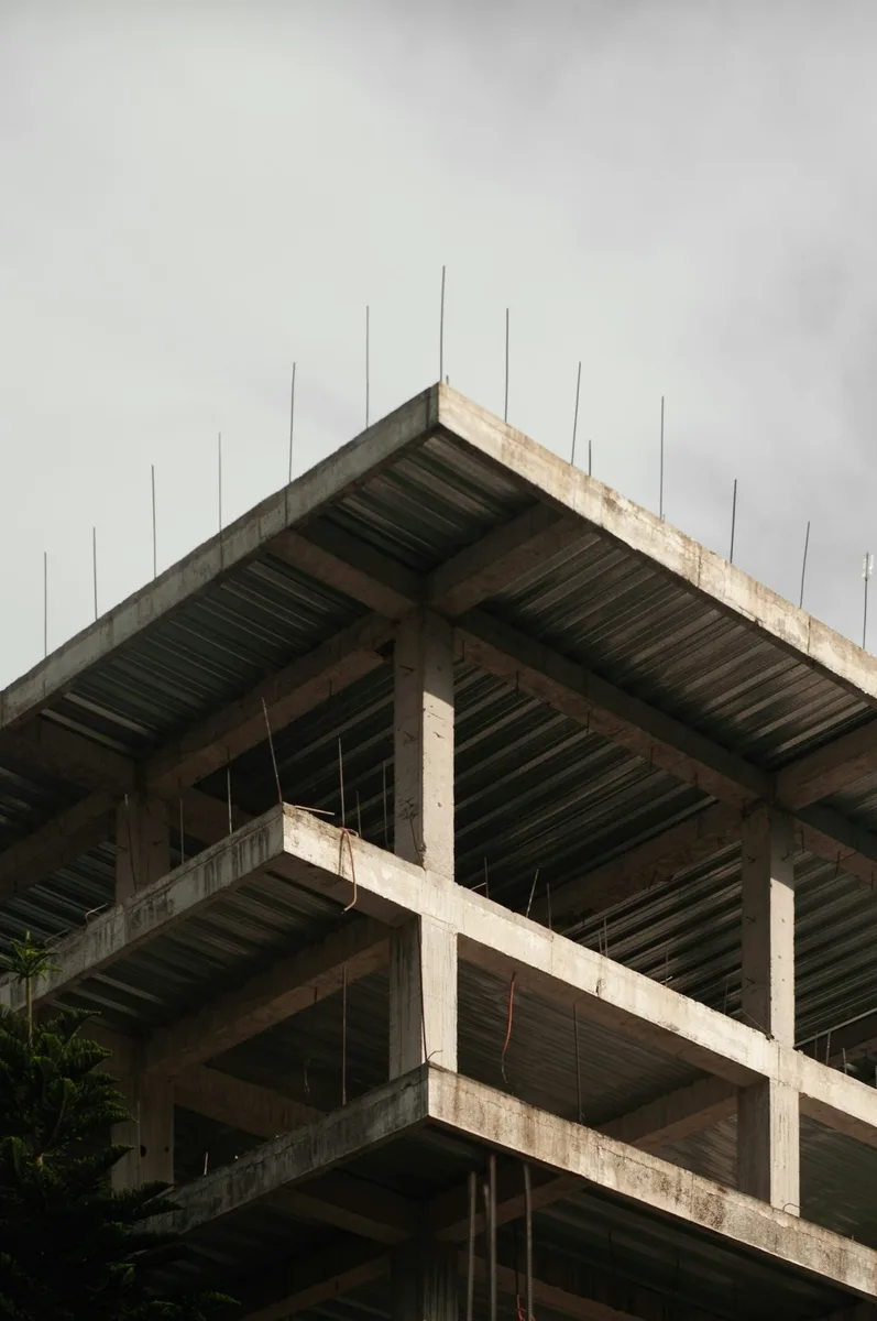 Commercial construction cost estimation documents, blueprints, and digital surveying calipers